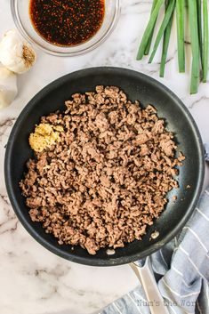 the ingredients for this meat and vegetable dish are in a skillet, ready to be cooked