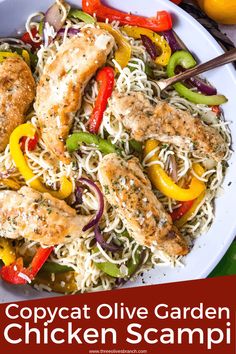 a white bowl filled with chicken, peppers and noodles next to some sliced oranges