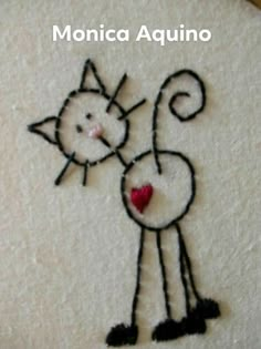 an embroidered picture of a cat with a heart on it's back and the words monica acquinno written in spanish