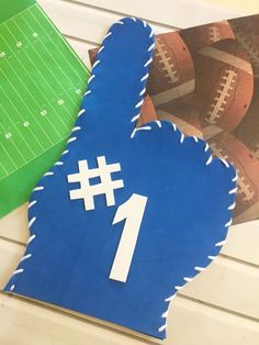 a paper cut out of the shape of a number 1 with footballs in the background