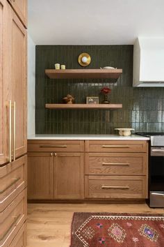 a kitchen with wooden cabinets and green tile backsplashing on the back wall