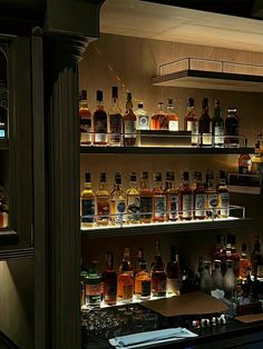 shelves filled with liquor bottles in a bar