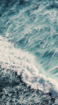 an aerial view of the ocean with waves