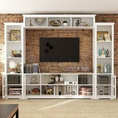 an entertainment center with bookshelves and a flat screen tv mounted on the wall