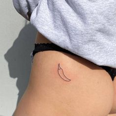 a small tattoo on the side of a woman's stomach