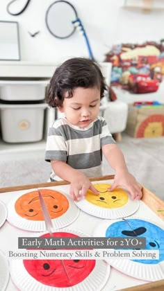 a young child is playing with paper plates