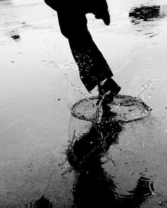 black and white photograph of a person jumping in the water