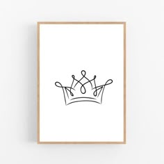 a black and white drawing of a crown on a wall above a wooden framed frame