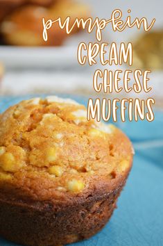 pumpkin cream cheese muffins on a blue plate with the words pumpkin cream cheese muffins