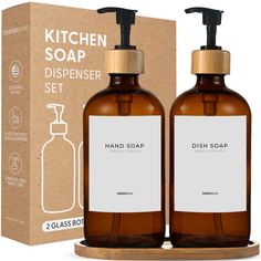 two brown soap bottles sitting next to each other in front of a cardboard box on a white background