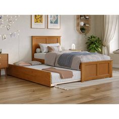 a bed sitting on top of a wooden floor