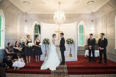 a bride and groom are getting married in front of the altar at their wedding ceremony