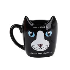 a black mug with a cat's face painted on the side and words that read, i work hard to my cat can have a better life