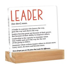 a wooden stand with a sign on it that says leader and an image of the poem