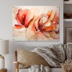 a living room scene with focus on the couch and wall art that has flowers painted on it