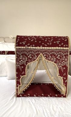 a bed with a red and white canopy over it