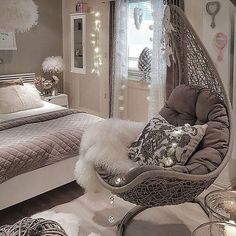 a bedroom decorated in white and grey with lots of lights