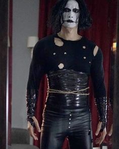 a man with white makeup and black leather outfit