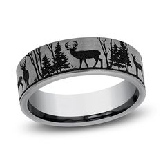 a wedding band with deer and trees in the woods on an 18k white gold ring