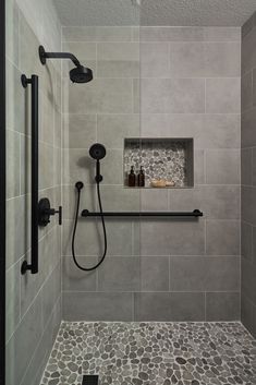 Bathroom Remodeling Ideas -  A transitional shower design with river rock floor and niche accent. Large format grey tile on the walls. Matte black fixtures. Restroom Remodel, Tub To Shower Remodel, Bathroom Decor Ideas