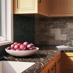 a bowl full of fruit sitting on top of a kitchen counter