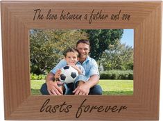 a father and son holding a soccer ball in front of a wooden frame that says, the love between a father and son last forever