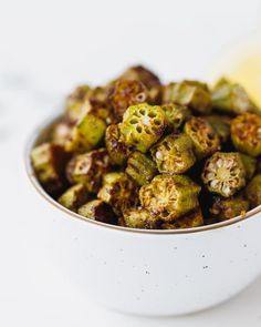 a white bowl filled with cooked brussel sprouts