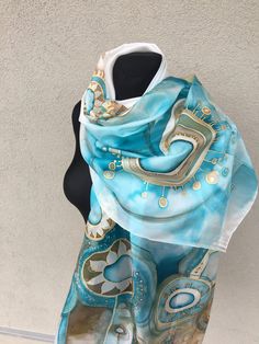 Large and long teal silk scarf hand painted. Floral teal, tan and blue art on the white background. 100% pure silk ponge 5 shawl. The designer silk scarf is a nice 12 anniversary or gift for her  ✿-----Item details: ON ORDER ONLY *This scarf was made by order, I will make a similar, but not the same because this is a handmade product. The photo is just a sample. At your request, the scarf can be personalized by entering the name, monogram, or initials. ✿-----Available sizes: 40x150 cm /20x60 in Bohemian Blue Silk Scarf As Gift, Artsy Blue Scarf As Gift, Artsy Blue Scarf As A Gift, Artsy Blue Scarf Perfect As A Gift, Artsy Blue Silk Scarf As Gift, Bohemian Blue Silk Scarf For Gift, Artsy Blue Scarves As Gifts, Artsy Blue Scarf For Gift, Bohemian Blue Silk Scarf Gift