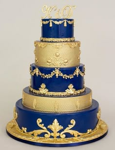 a three tiered blue and gold wedding cake