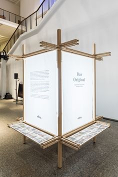 a large white display case sitting on top of a carpeted floor next to a stair case