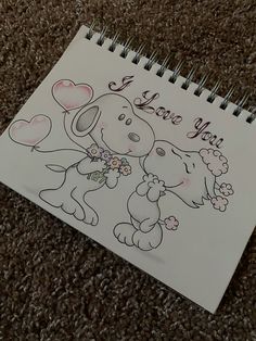 a notepad with a drawing of a dog holding a teddy bear and the words i love you on it