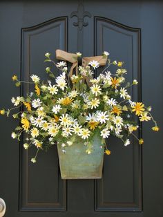 a black and white photo of flowers in a planter on the front door sill