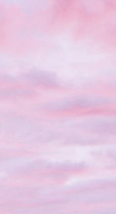 an airplane is flying in the sky with pink and blue clouds behind it at sunset