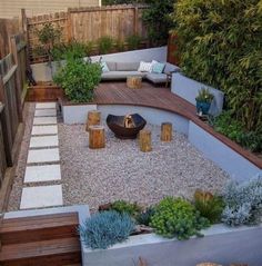 an outdoor seating area with stone steps and gravel