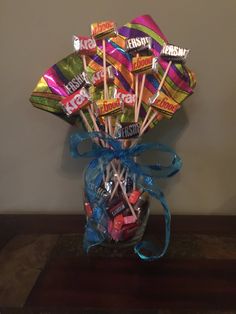 a vase filled with assorted candy and lollipops