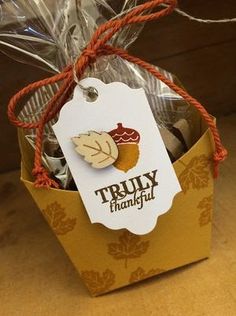 a small gift bag filled with cookies and candies for someone's thanksgiving party