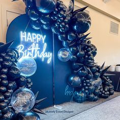 a birthday arch made out of balloons with the words happy birthday written on it