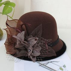 Gurl, dress your look to the nines with the perfect headwear. Our wide variety of hats guarantee you'll look your best for any event. Our fedora style hat is a chic accessory, adorned with a flower for an elegant touch. Daddies and Drags alike will love our selection, all crafted from wool and cotton for the utmost comfort. Make Hat Queen Orchya's Fedoras your crowning glory! Material: Wool, Cotton Item Type: Fedoras Head Circumference: 22"- 22.8" / 56cm - 58cm Gatsby Style Wide Brim Adjustable Hats, Flat Brim Top Hat For Winter Party, Elegant Costume Hats With Curved Brim For Winter, Elegant Winter Costume Hats With Curved Brim, Winter Party Top Hat With Curved Brim, Winter Party Top Hat With Short Brim, Elegant Brown Top Hat For Winter, Winter Party Top Hat With Flat Brim, Elegant Party Hats For Fall