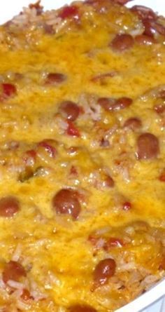 a casserole dish with meat and cheese on it in a white dish, ready to be eaten