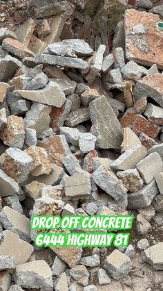 a pile of rocks with the words drop off concrete below it