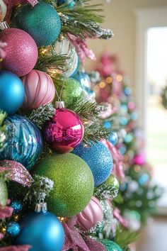 the christmas tree is decorated with colorful ornaments