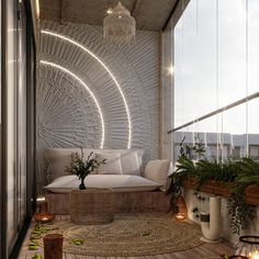 a living room filled with lots of furniture next to a large window covered in plants