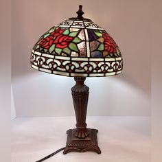 a stained glass lamp on a wooden stand