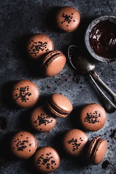 chocolate macaroons with sprinkles next to a spoon