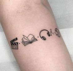 a tattoo with books and headphones on it