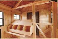 the inside of a chicken coop with several chickens in it's cage and windows