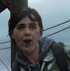 a young boy standing in front of a telephone pole with his mouth open and tongue out