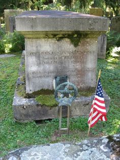 an american flag is placed next to a grave