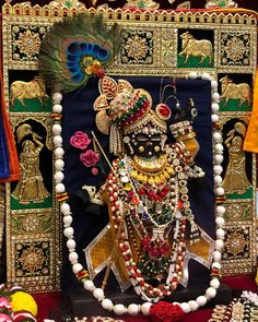 an idol is displayed with beads and other decorations