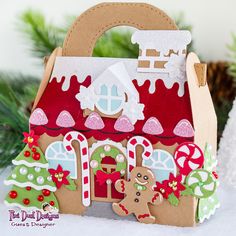 a handmade gingerbread house is decorated with candy canes and christmas decorations for the holiday season